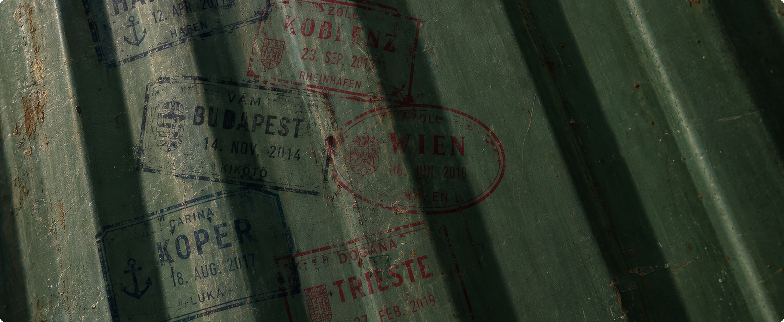 Customs stamps from Koblenz, Budapest and Vienna on a green container wall