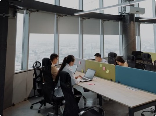 Colleagues working at desks in a high-rise office
