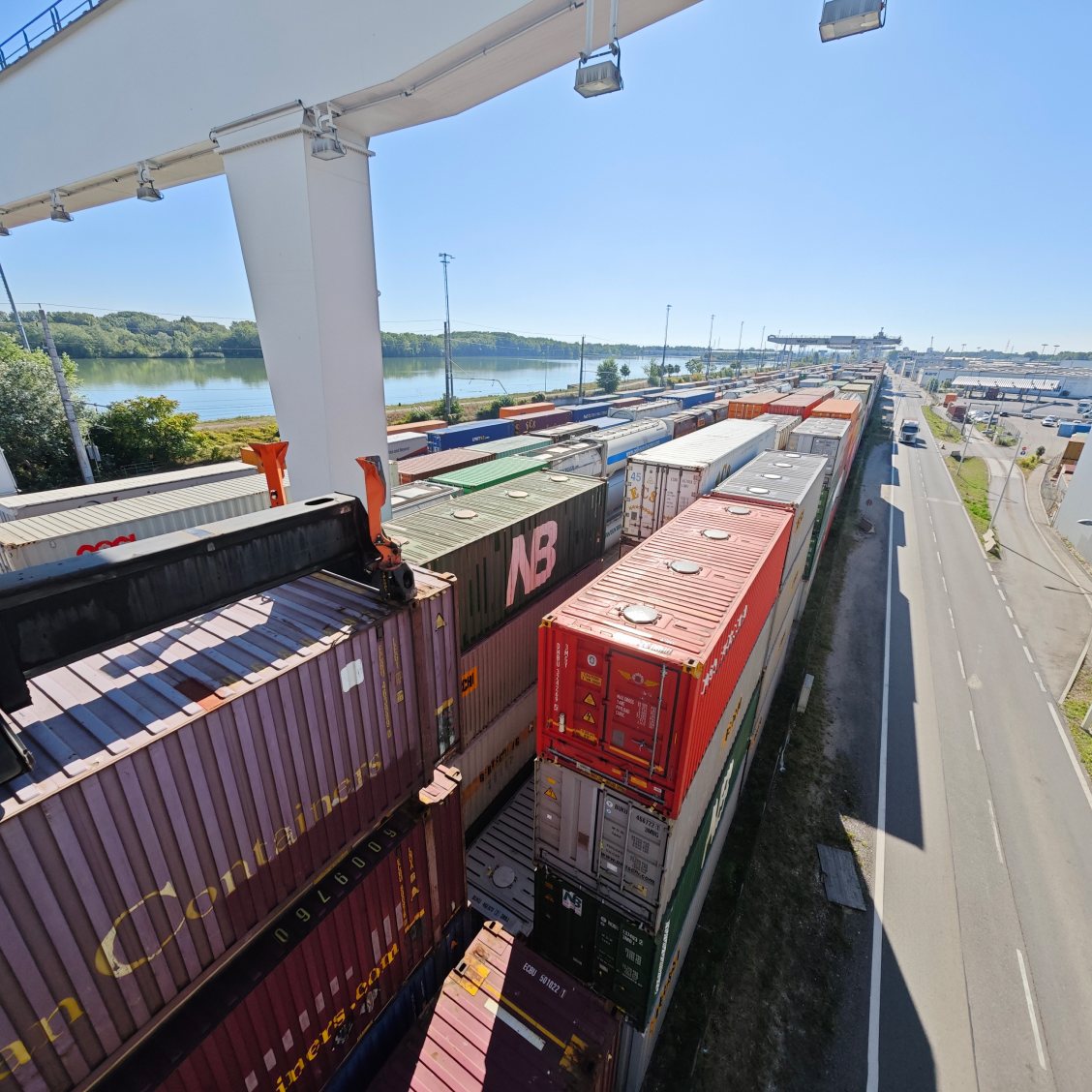 Container trains at an intermodal terminal next to a river