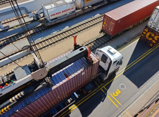 Gantry crane transferring a container from rail to truck